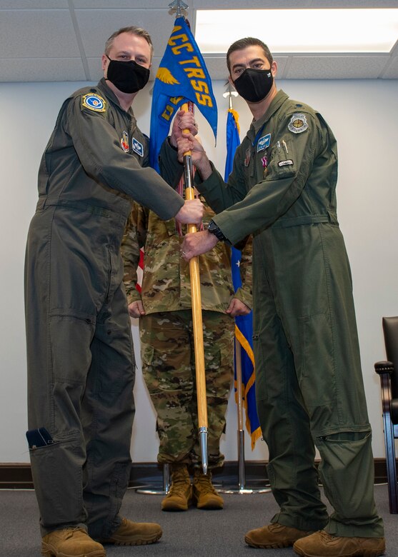 Lt. Col. Mike El Mann, right, Headquarters Training Support Squadron Detachment 15 commander, relinquishes command of the Detachment 15 guidon to Lt. Col. Scott Major, Air Combat Command Training Support Squadron commander, during the Detachment 15 change of command ceremony at Seymour Johnson Air Force Base, North Carolina, April 9, 2021.