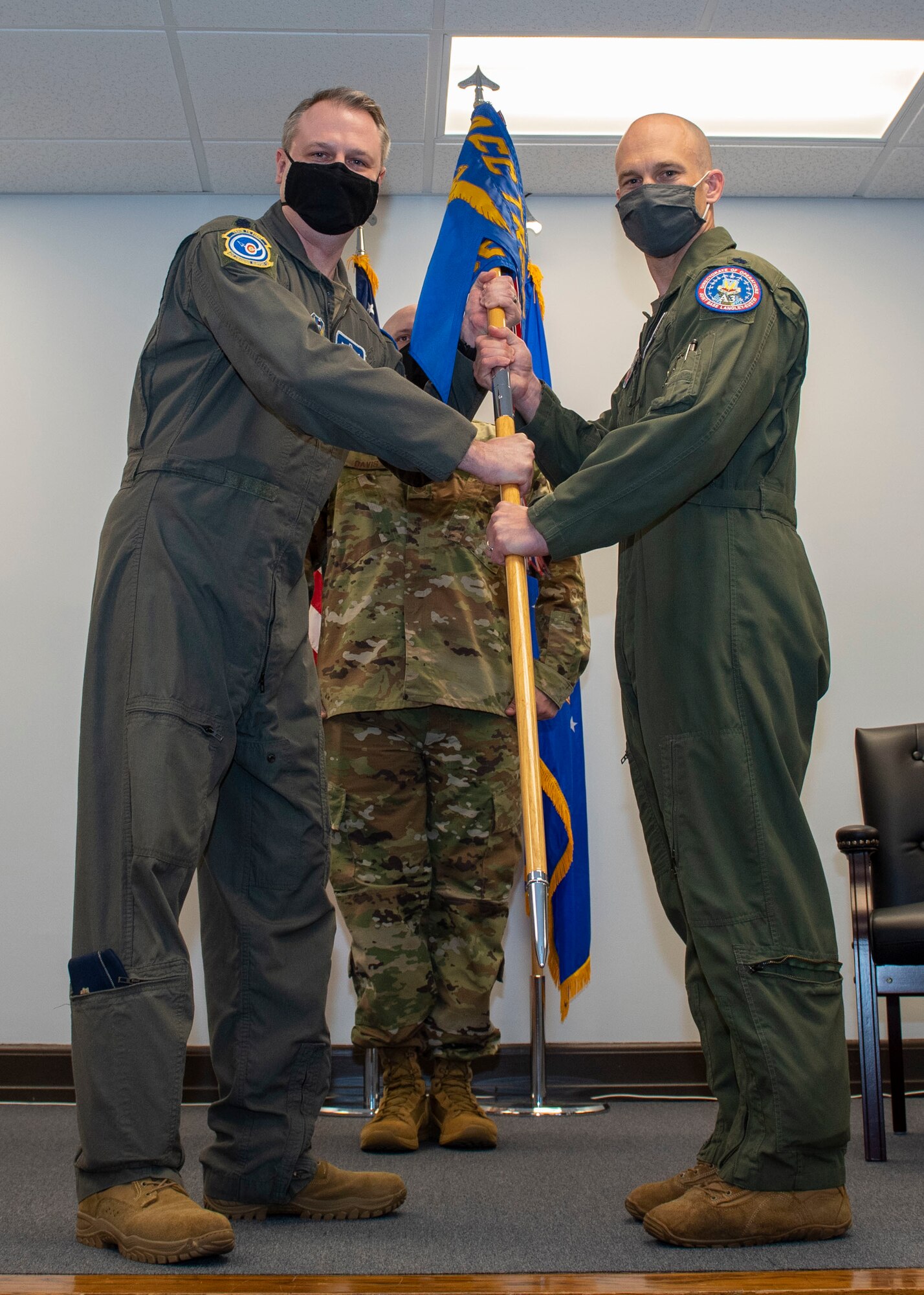 Lt. Col. Tanner Hein, right, incoming Headquarters Training Support Squadron Detachment 15 commander, receives the guidon from Lt. Col. Scott Major, Air Combat Command Training Support Squadron commander, during the Detachment 15 change of command ceremony at Seymour Johnson Air Force Base, North Carolina, April 9, 2021.