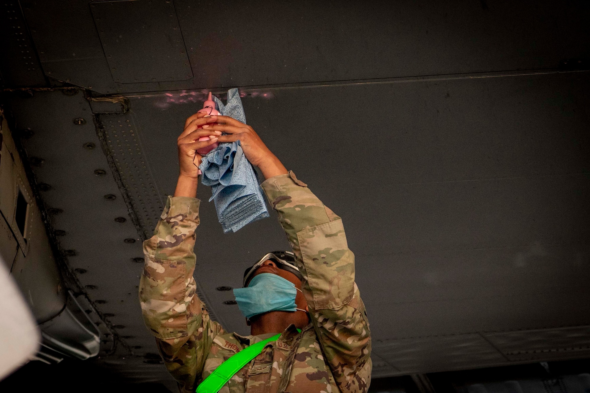 U.S. Air Force Airman 1st Class Justin Thomas, a fuel systems apprentice assigned to the 1st Special Operations Maintenance Squadron, applies talcum powder to the wing of an MC-130H Combat Talon II to check for a fuel leak, Hurlburt Field, Florida, April 5, 2021.