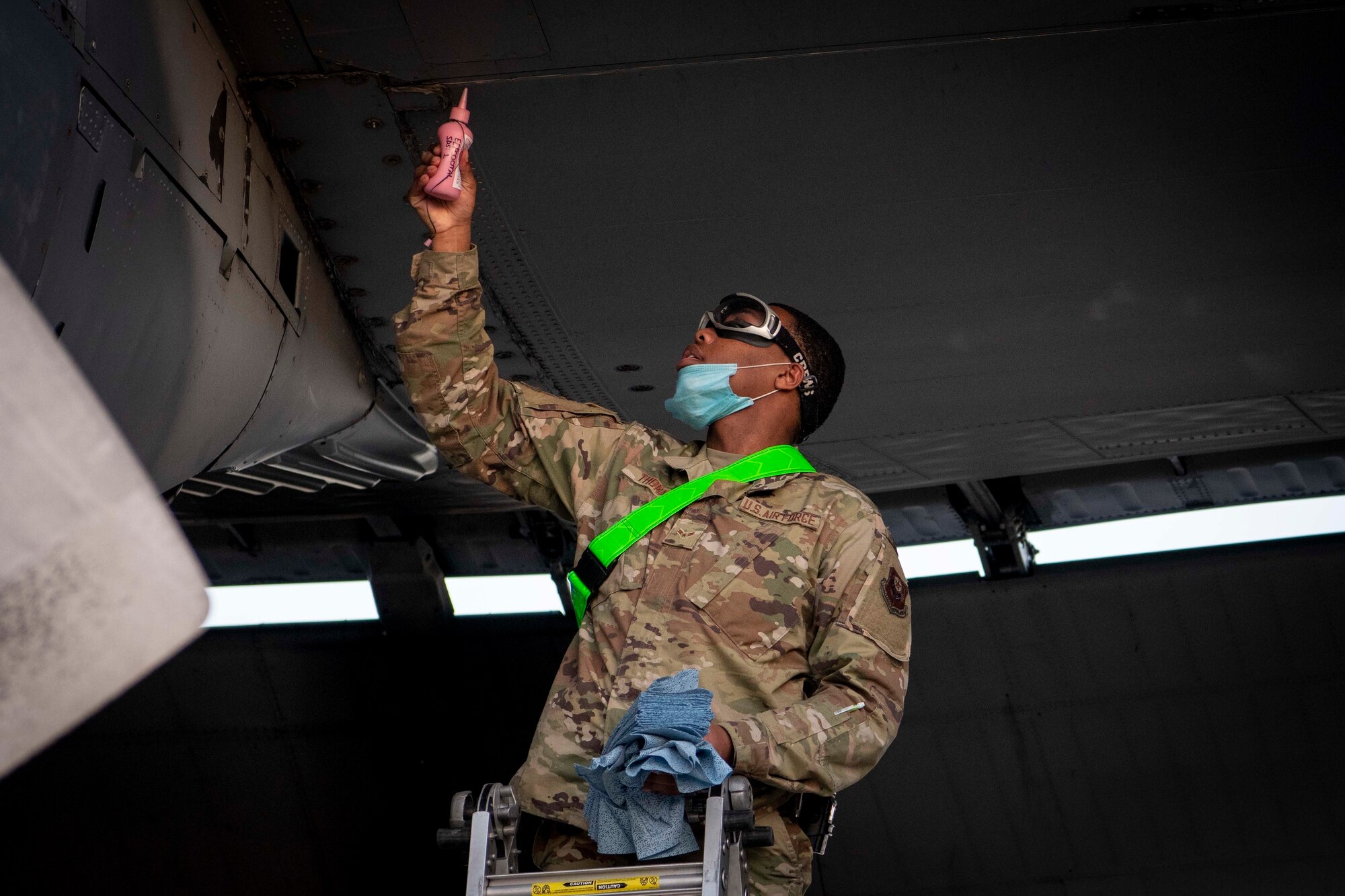 U.S. Air Force Airman 1st Class Justin Thomas, a fuel systems apprentice assigned to the 1st Special Operations Maintenance Squadron, applies talcum powder to the wing of an MC-130H Combat Talon II to check for a fuel leak at Hurlburt Field, Florida, April 5, 2021.