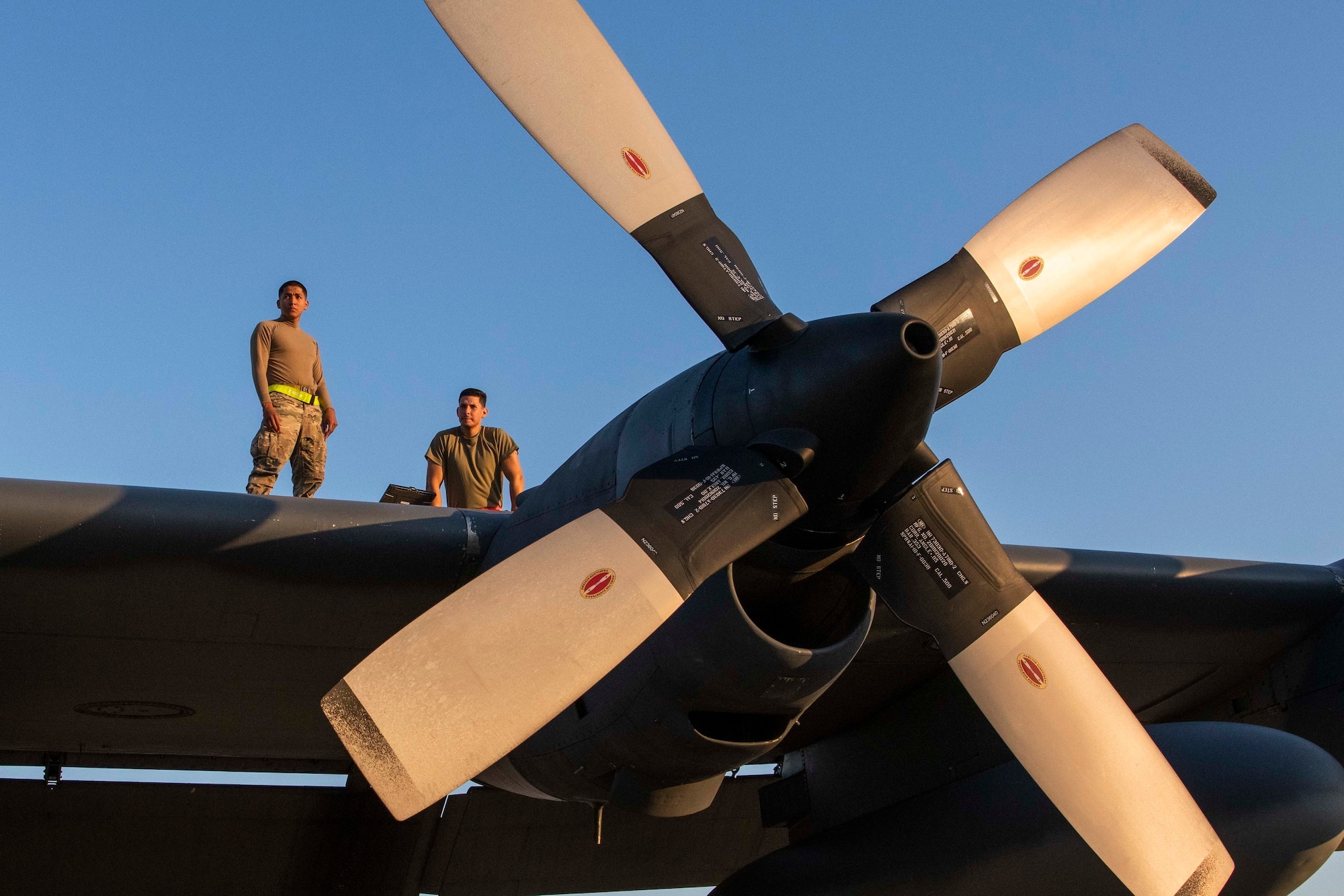 U.S. Air Force Airman 1st Class Jared Agustin, a fuels systems apprentice assigned to the 1st Special Operations Maintenance Squadron and U.S. Air Force Senior Airman Henry Rivas, a fuels system apprentice assigned to the 1st SOMXS inspect the wing of an MC-130H Combat Talon II at Hurlburt Field, Florida, April 5, 2021.