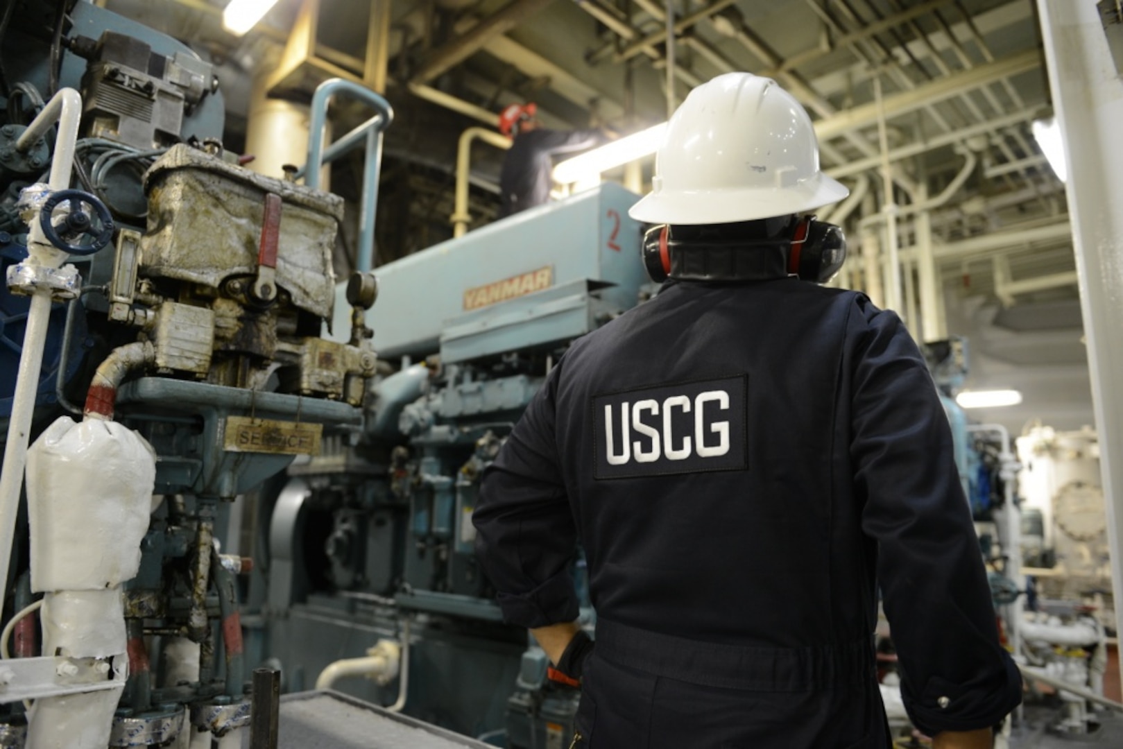 A marine inspector with Coast Guard Sector Miami inspects the engine room of a container ship Sept. 1, 2014. Marine inspectors identify deficiencies aboard domestic and foreign vessels to prevent oil spills and the loss of life. (U.S. Coast Guard photo by Petty Officer 3rd Class Mark Barney)