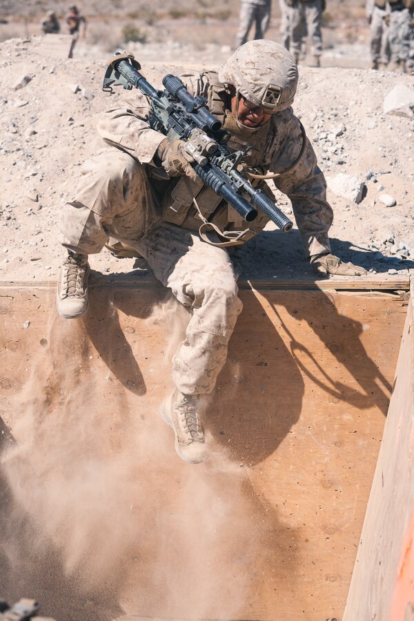 A U.S. Marine with Company B, 1st Battalion, 5th Marine Regiment, jumps into a trench during the Platoon Attacks at Range 410A while participating in Integrated Training Exercise (ITX), 3-21 at Marine Corps Air Ground Combat Center, Twentynine Palms, California, April 9, 2021. The purpose of ITX is to create a challenging, realistic training environment that produces combat-ready forces capable of operating as an integrated Marine Air Ground Task Force.  (U.S. Marine Corps photo by Lance Cpl. Andrew R. Bray)