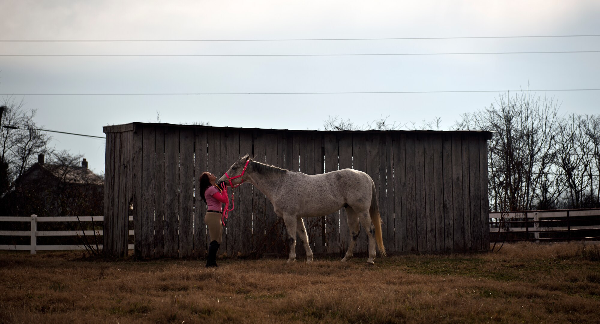 Airman 1st Class Kaitlyn Evans, an 11th Security Forces Squadron patrolman, poses for a portrait with her horse Kobalt in Lothian, Maryland, after her military duty day is complete. Evans, a North Carolina native, relocated her horse to Maryland at her own expense to continue competing with the horse. Spending about two hours of time with her horse has helped Evans cope physically and mentally as she begins her military career. (U.S. Air Force photo/Staff Sgt. Vernon Young Jr.)