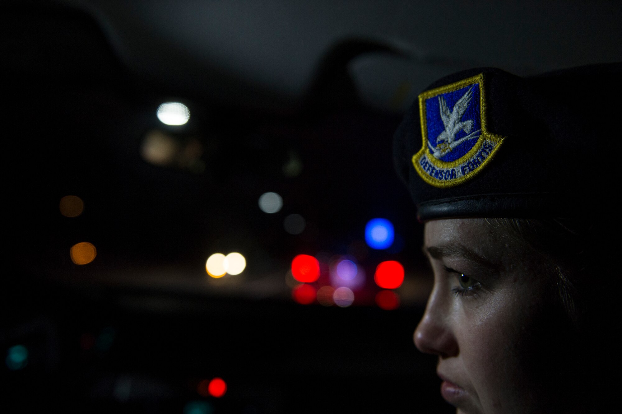 Airman 1st Class Kaitlyn Evans receives on-the-job training from Senior Airman Daniel Hayes as she prepares to approach a vehicle during a routine traffic violation while on night-shift duty at Joint Base Andrews, Maryland. During the evening hours, her role as a patrolman is to secure the base and maintain the safety of personnel. Evans and Hayes are patrolmen assigned to the 11th Security Forces Squadron at Andrews Air Force Base, Maryland. (U.S. Air Force photo/Staff Sgt. Vernon Young Jr.)