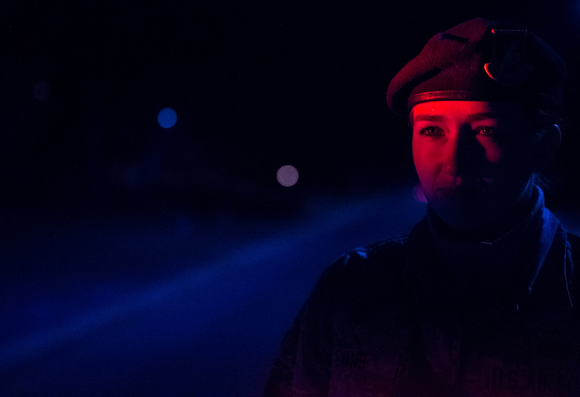 Airman 1st Class Kaitlyn Evans, an 11th Security Forces Squadron patrolman, surveys the road while on night-shift duty at Joint Base Andrews, Maryland. During the evening hours, her role as a patrolman is to secure the base and maintain the safety of personnel. Her attention to detail and military discipline serves as key components to maintaining the demands of owning a horse and performing well at work. (U.S. Air Force photo/Staff Sgt. Vernon Young Jr.)