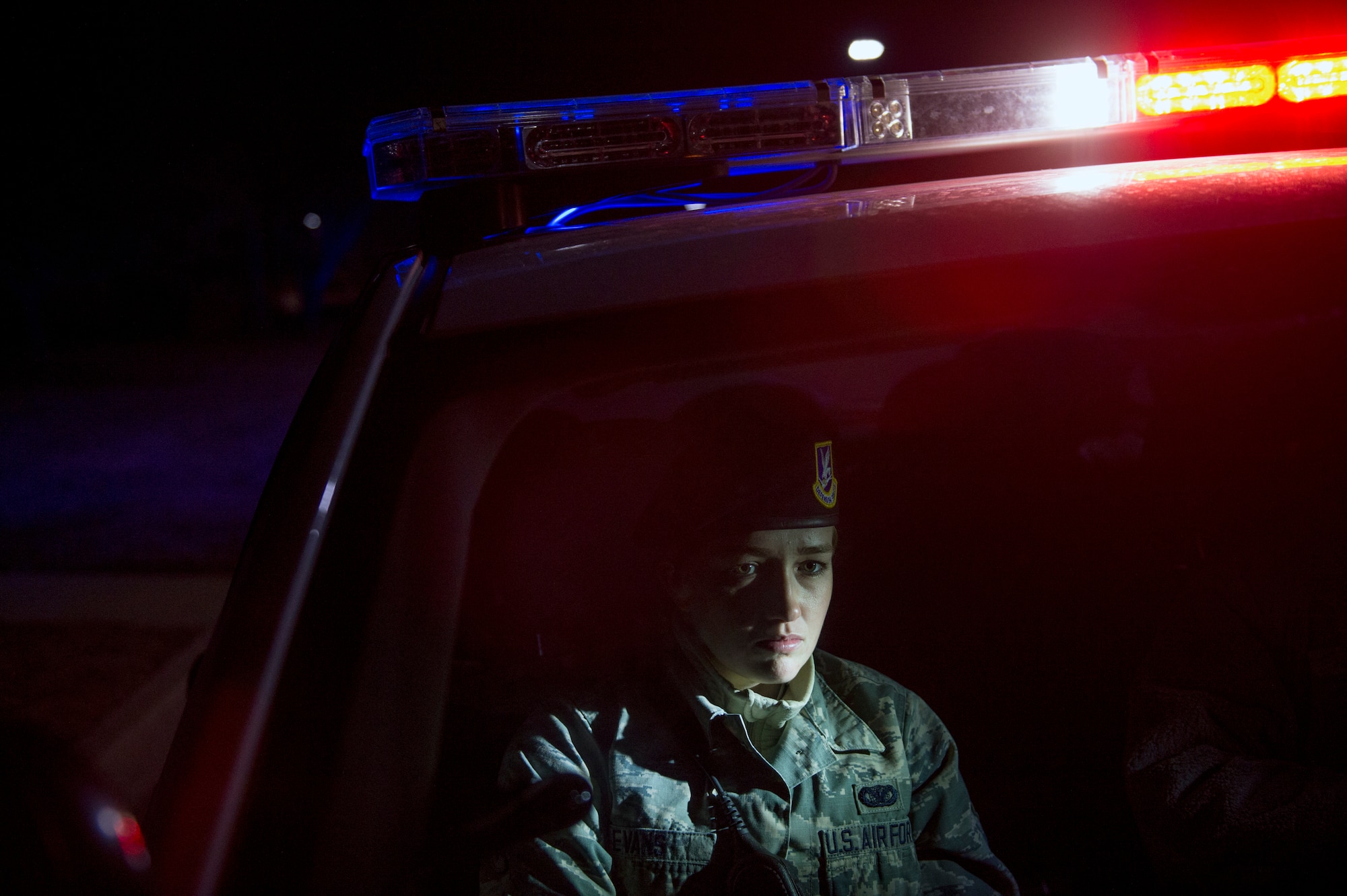 Airman 1st Class Kaitlyn Evans receives on-the-job training from Senior Airman Daniel Hayes as she prepares to approach a vehicle during a routine traffic violation while on night-shift duty at Joint Base Andrews, Maryland. During the evening hours, her role as a patrolman is to secure the base and maintain the safety of personnel. Evans and Hayes are patrolmen assigned to the 11th Security Forces Squadron at Andrews Air Force Base, Maryland. (U.S. Air Force photo/Staff Sgt. Vernon Young Jr.)