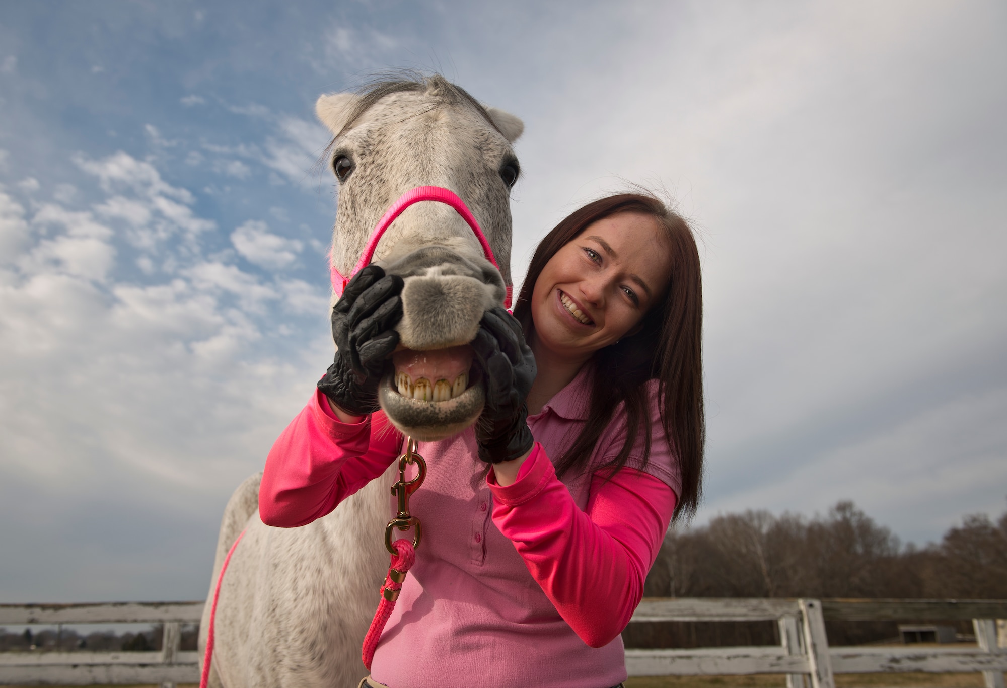 Airman 1st Class Kaitlyn Evans, an 11th Security Forces Squadron patrolman, poses for a portrait with her horse Kobalt in Lothian, Maryland after her military duty day is complete. Evans, a North Carolina native, relocated her horse to Maryland at her own expense to continue competing with the horse. Spending about two hours of time with her horse has helped Evans cope physically and mentally as she begins her military career. (U.S. Air Force photo/Staff Sgt. Vernon Young Jr.)