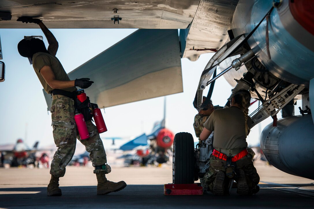Airmen clean an aircraft.