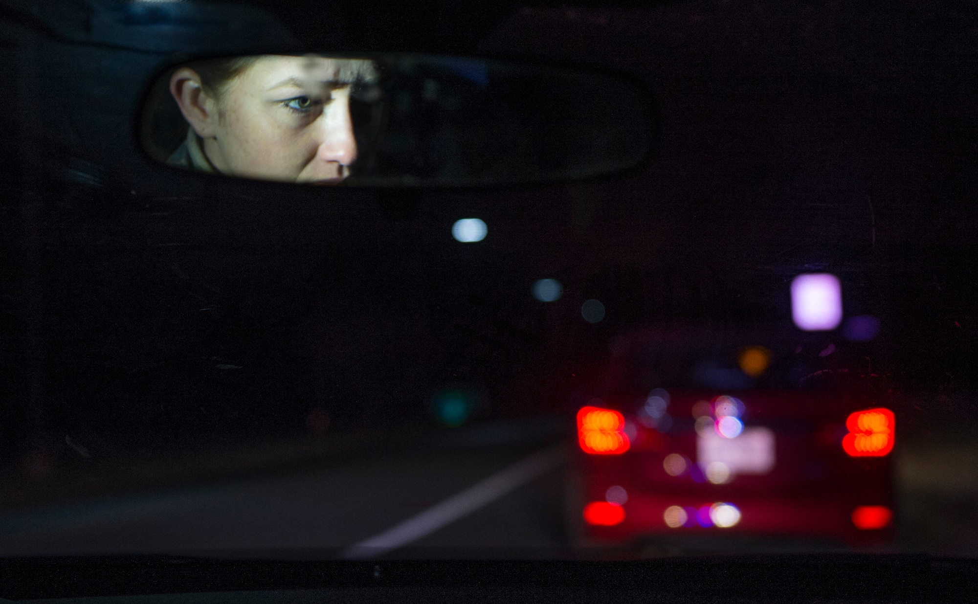Airman 1st Class Kaitlyn Evans, an 11th Security Forces Squadron patrolman, prepares to approach a vehicle during a routine traffic violation while on night-shift duty at Joint Base Andrews, Maryland. During the evening hours, her role as a patrolman is to secure the base and maintain the safety of personnel. Her attention to detail and military discipline serves as key components to maintaining the demands of owning a horse and performing well at work. (U.S. Air Force photo/Staff Sgt. Vernon Young Jr.)