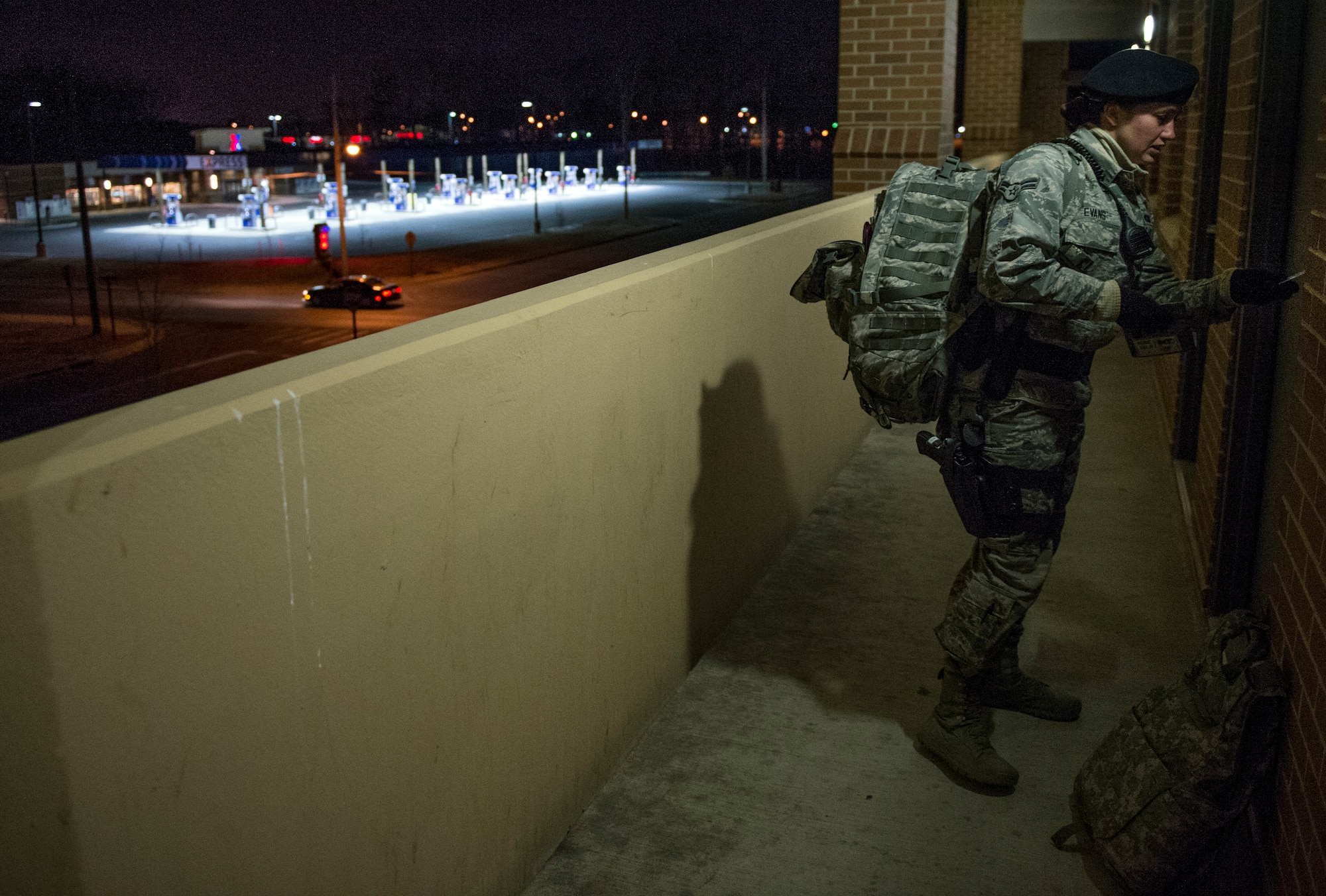 Airman 1st Class Kaitlyn Evans, an 11th Security Forces Squadron patrolman, leaves her dorm room as she prepares for night-shift duty at Joint Base Andrews, Maryland. Evans works throughout the night and maintains a horse through the daytime. Her attention to detail and military discipline serves as key components to maintaining the demands of owning a horse and performing well at work. (U.S. Air Force photo/Staff Sgt. Vernon Young Jr.)