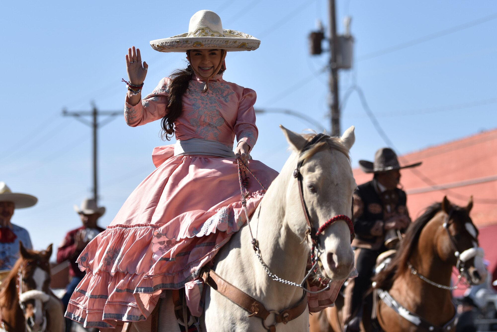 A Charros De Rancho Cabrera rider waves during the 89th Annual San Angelo Rodeo parade through downtown San Angelo, Texas, April 10, 2021. The entries rode or drove through downtown while individuals could watch from the sidelines. (U.S. Air Force photo by Staff Sgt. Seraiah Wolf)