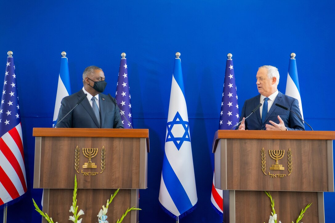 Defense Secretary Lloyd J. Austin III and Israeli Minister of Defense Benny Gantz stands at podiums.