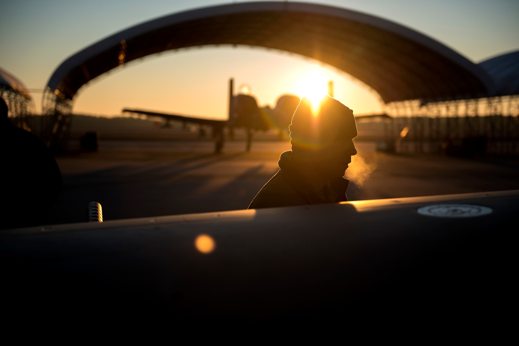 A U.S. Air Force weapons advisor prepares to load training bombs on an A-29 Super Tucano during the cold early morning hours at Moody Air Force Base, Georgia. (U.S. Air Force photo/Master Sgt. Jeffrey Allen
