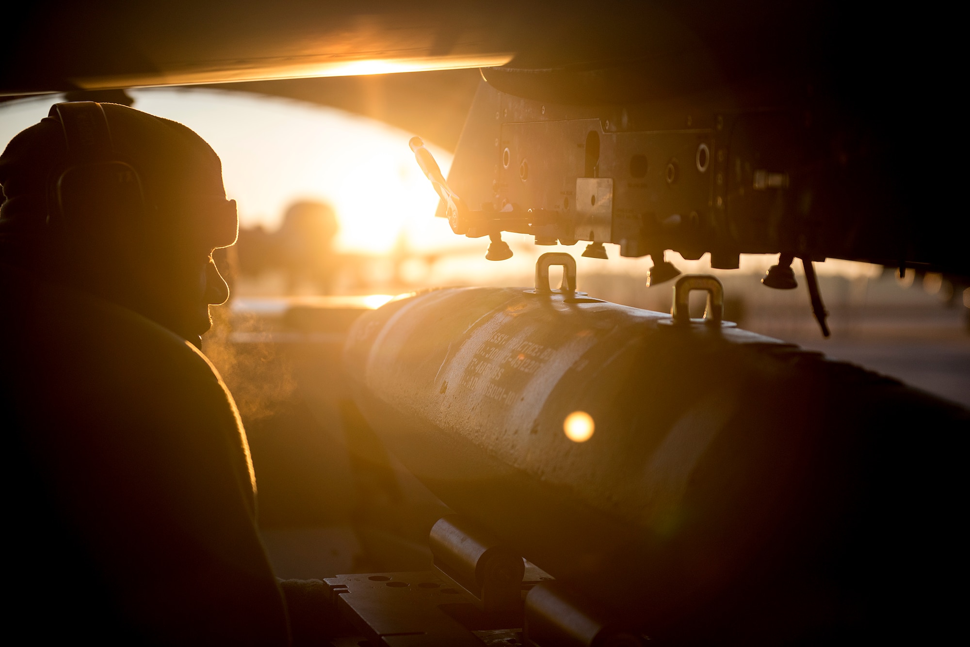A U.S. Air Force weapons advisor loads a training bomb on an A-29 Super Tucano during the cold early morning hours at Moody Air Force Base, Georgia. (U.S. Air Force photo/Master Sgt. Jeffrey Allen)