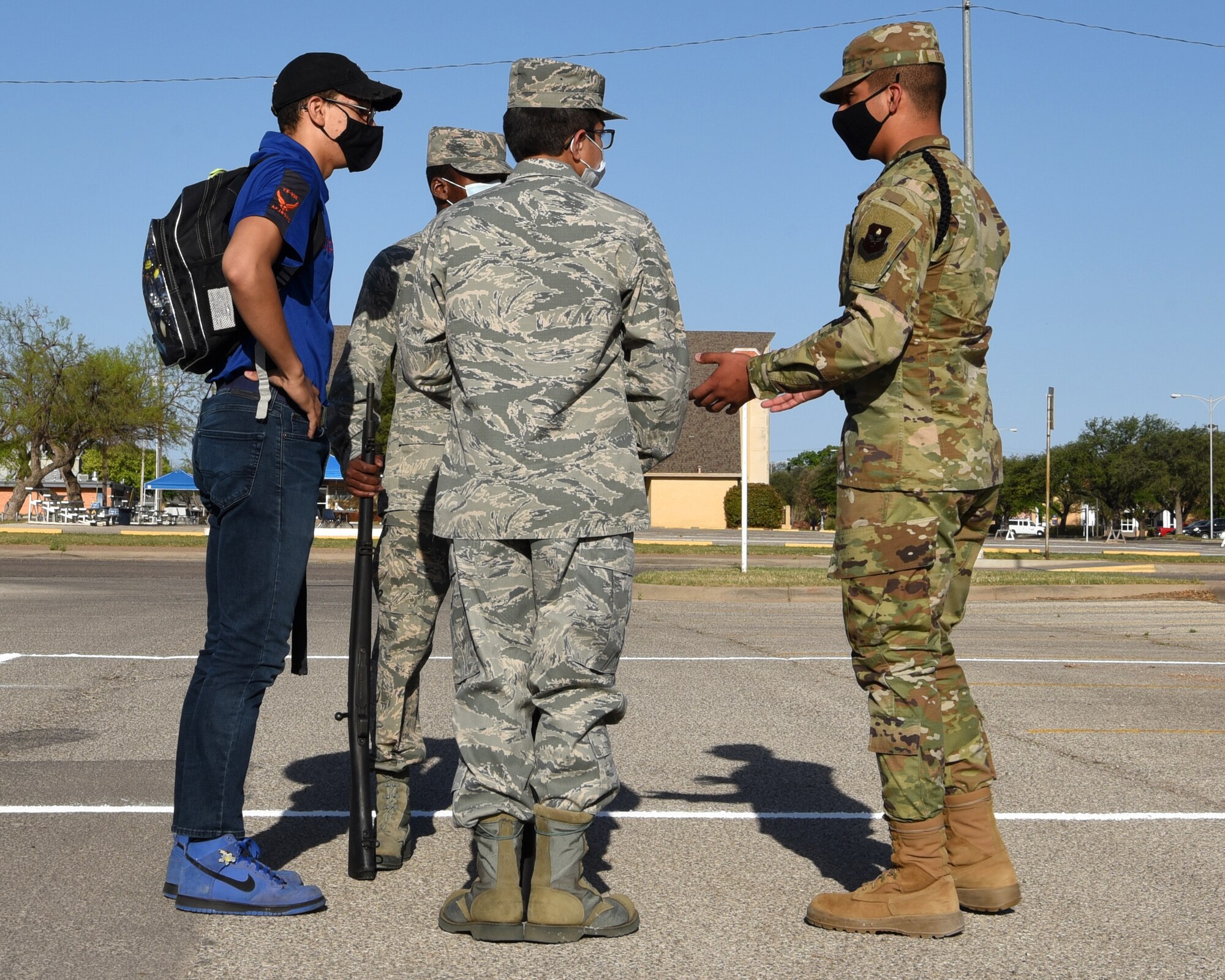 U.S. Air Force Airman 1st Class Jose Delgado, 315th Training Squadron student drill team member, offers drill advice to participants in the Air Force ROTC Detachment 847’s Annual Drill Meet, at Angelo State University in San Angelo, Texas, April 10, 2021. As a student drill team member, Delgado is in charge of marching technique and precision for fellow peers at the 315th TRS. (U.S. Air Force photo by Senior Airman Abbey Rieves)