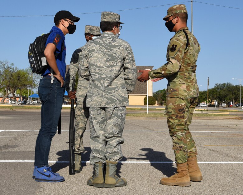 U.S. Air Force Airman 1st Class Jose Delgado, 315th Training Squadron student drill team member, offers drill advice to participants in the Air Force ROTC Detachment 847’s Annual Drill Meet, at Angelo State University in San Angelo, Texas, April 10, 2021. As a student drill team member, Delgado is in charge of marching technique and precision for fellow peers at the 315th TRS. (U.S. Air Force photo by Senior Airman Abbey Rieves)