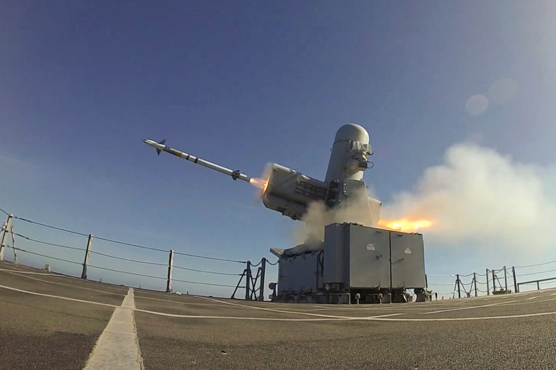 A missile fires from the deck of a ship.