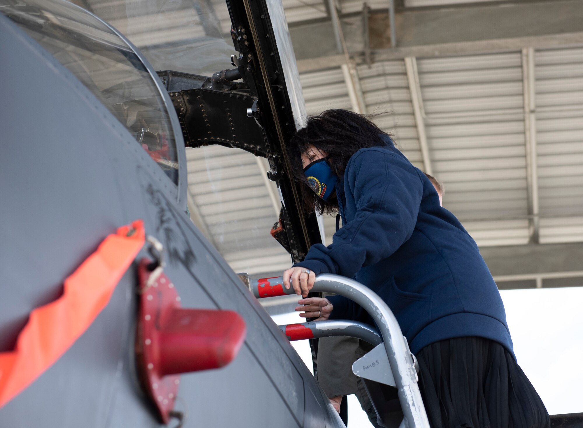 A woman is looking into an F-15E Strike Eagle