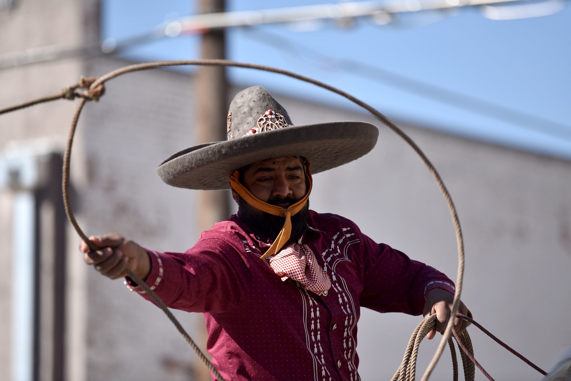 A Charros De Rancho Cabrera contestant performs lasso tricks during the 89th Annual San Angelo Rodeo parade through downtown San Angelo, Texas, April 10, 2021. They won third place in both the 2018 and 2019 rodeo. (U.S. Air Force photo by Staff Sgt. Seraiah Wolf)