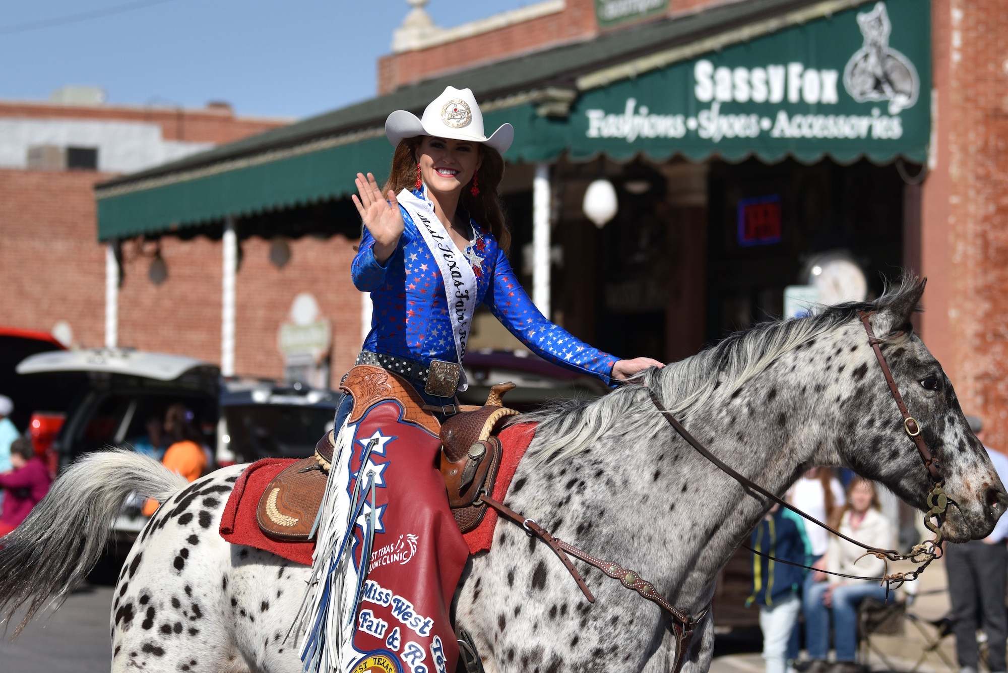 Bobbi Loran, Miss West Texas Fair and Rodeo, rides in the 89th Annual San Angelo Rodeo parade through downtown San Angelo, Texas, April 10, 2021. Competitors come from all different backgrounds, some even from out of state. (U.S. Air Force photo by Staff Sgt. Seraiah Wolf)