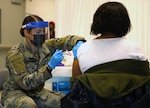 U.S. Army Spc. Kandris Spencer, a medical specialist assigned to the 10th Field Hospital, administers the COVID-19 vaccine April 2 at the state-run, federally-supported COVID-19 Community Vaccination Center at Trenton Central High School, New Jersey.