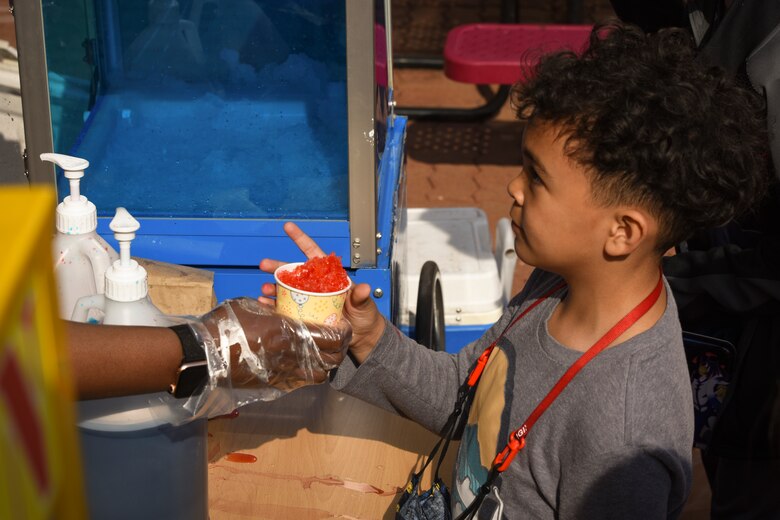 Children at the Day of Fun event for the Month of the Military Child wait in line for snow cones at Osan Air Base, Republic of Korea, April 9, 2021.