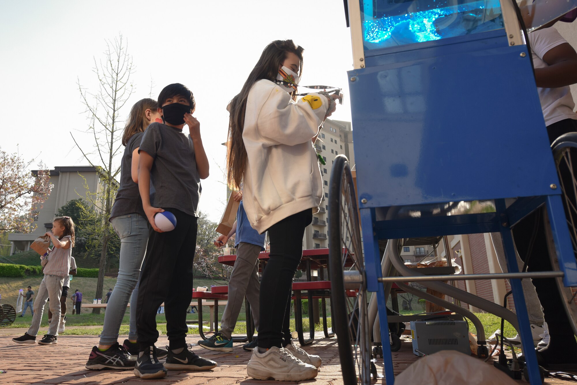 Children at the Day of Fun event for the Month of the Military Child wait in line for snow cones at Osan Air Base, Republic of Korea, April 9, 2021.