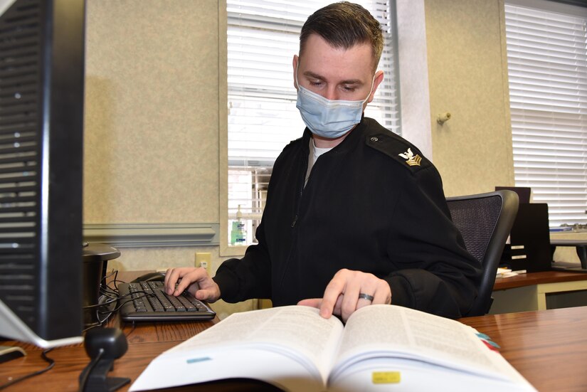 210203-N-N0443-1753 NORFOLK, Va. (Feb. 3, 2021) Legalman 1st Class Kevin Billings, assigned to Region Legal Service Office Mid-Atlantic, works at his desk Feb. 3, 2021. Billings created the Next Generation Study Planner, a customizable study plan for advancement exams now available on Navy COOL and MyNavy Portal. Billings started the planner three years ago when he realized that Sailors would benefit if they had assistance in creating study plans ahead of advancement exam administrations. (U.S. Navy photo by Lt. Carolina Gray)