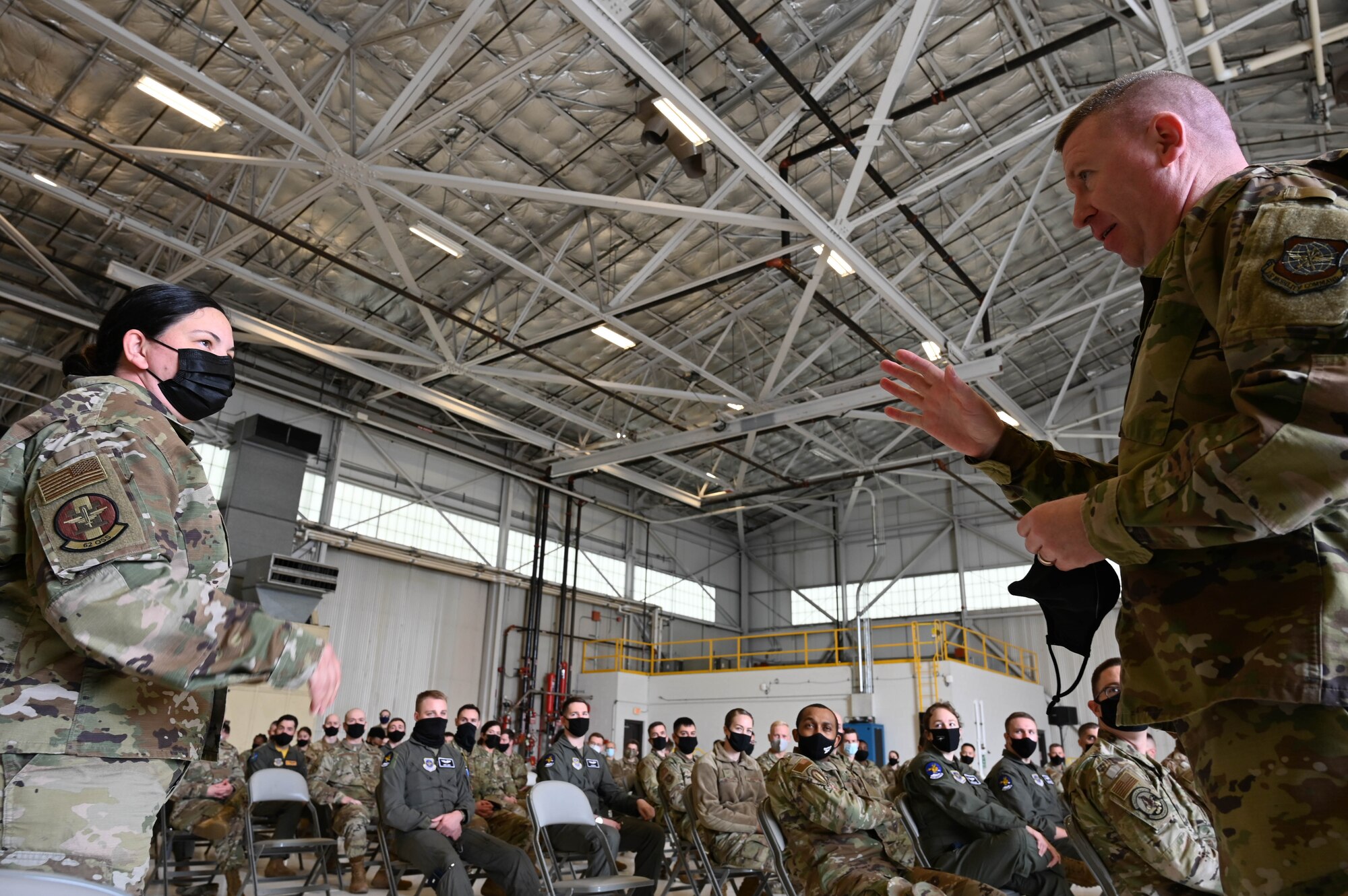 U.S. Air Force Master Sgt. Natasha Sanchez, assigned to the 62nd Operations Support Squadron, asks Chief Master Sgt. Chad Bickley, 18th Air Force command chief, a question during an all call at Joint Base Lewis-McChord, Washington, April 9, 2021. During their visit, 18th AF leadership learned about the wing’s unique mobility mission and met with Airmen across the base, seeing firsthand who makes up Team McChord. (U.S. Air Force photo by Airman 1st Class Callie Norton)
