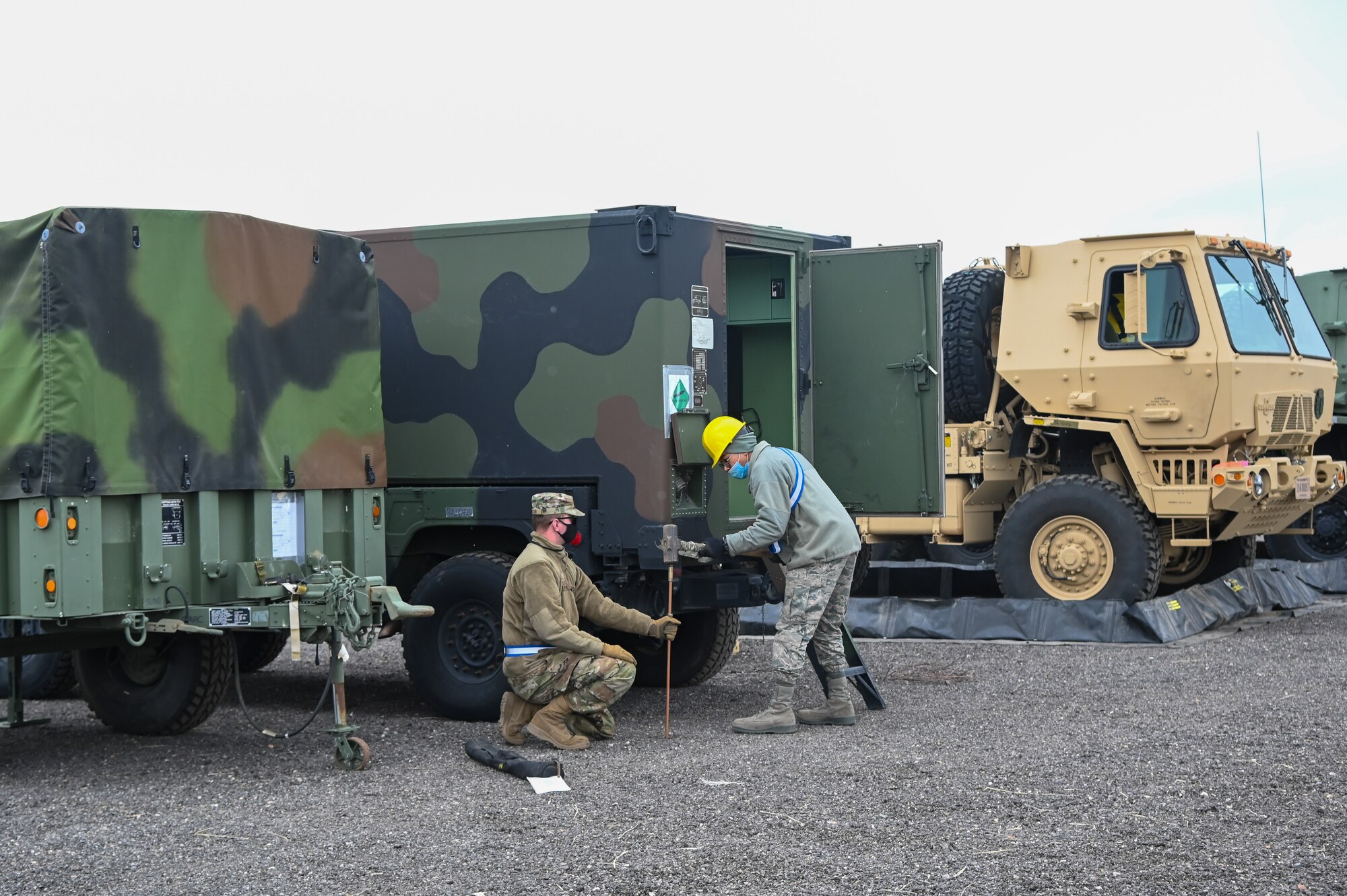 Airmen install a grounding pole.
