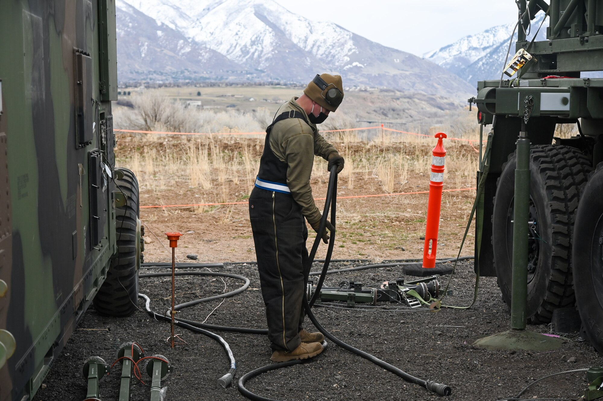 An Airman holding an electric cable.