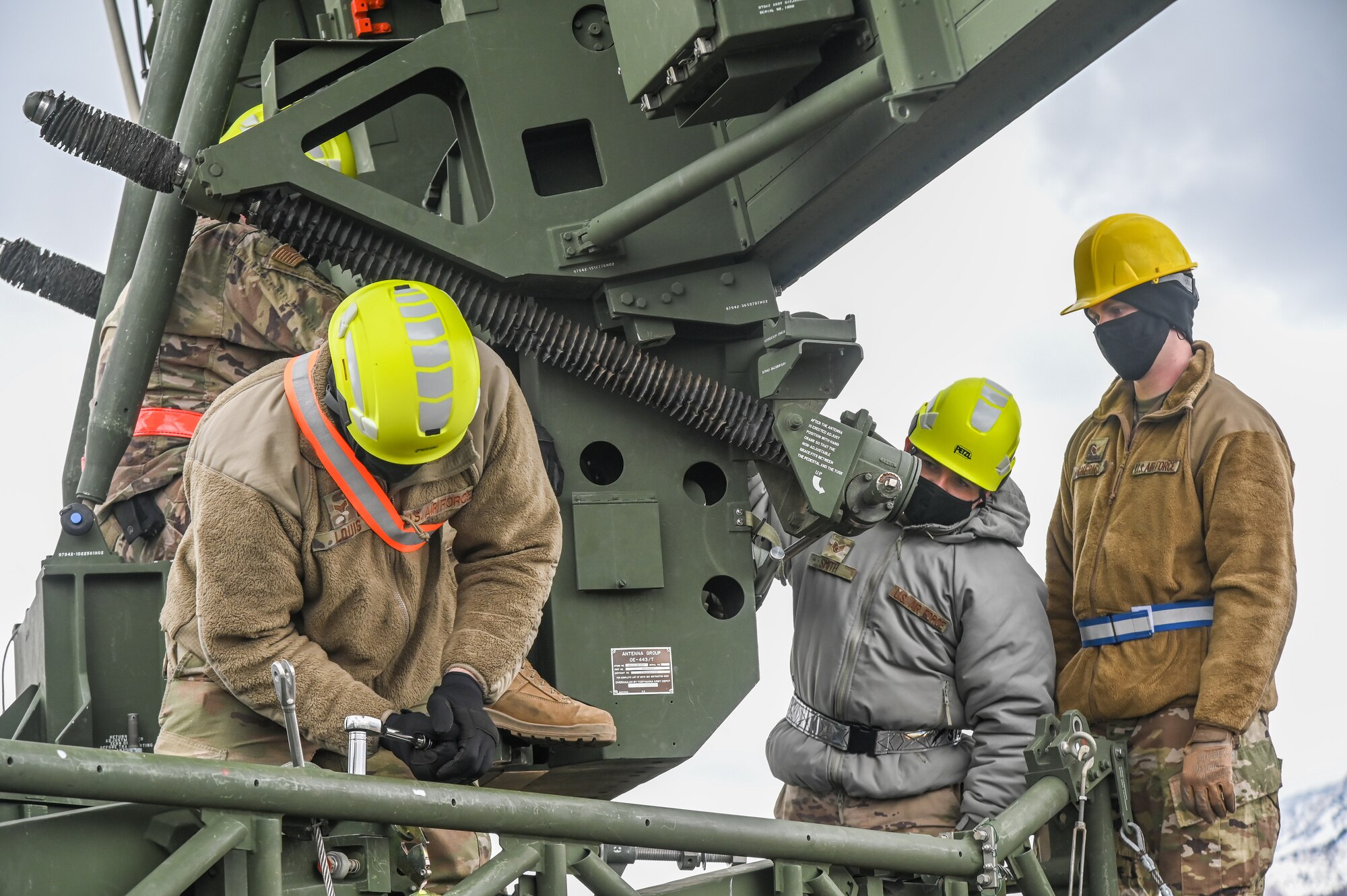 Three Airman working on an AN/TPS-75 radar system.