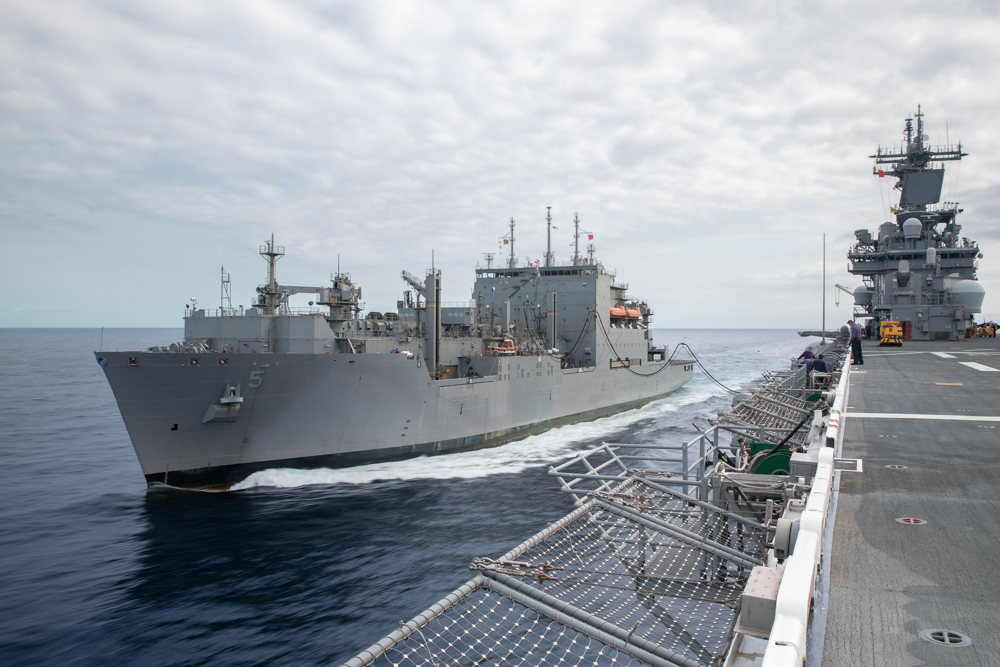 The  Lewis and Clark-class dry cargo and ammunition ship USNS Robert E. Peary (T-AKE 5) sails alongside the Wasp-class amphibious assault ship USS Kearsarge (LHD 3) during a replenishment-at-sea.