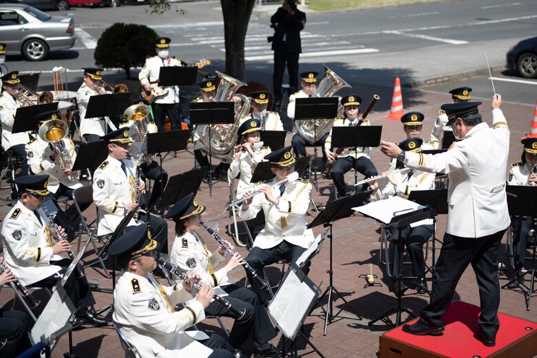 The Japanese National Police Band plays music during a concert at the Yokota Community Center on Yokota Air Base, Japan, April 11, 2021. The band played several songs including “The Armed Forces Medley” and a mashup of Disney songs as part of an event to help educate the audience on traffic safety. (U.S. Air Force photo by Staff Sgt. Joshua Edwards)