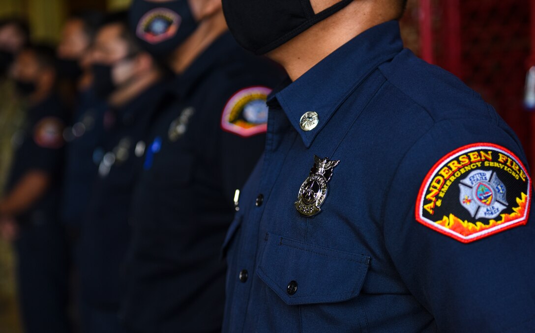 Firefighters stand at parade rest