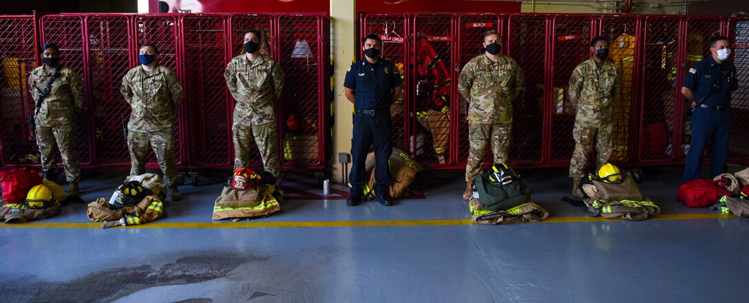 Firefighters stand at parade rest