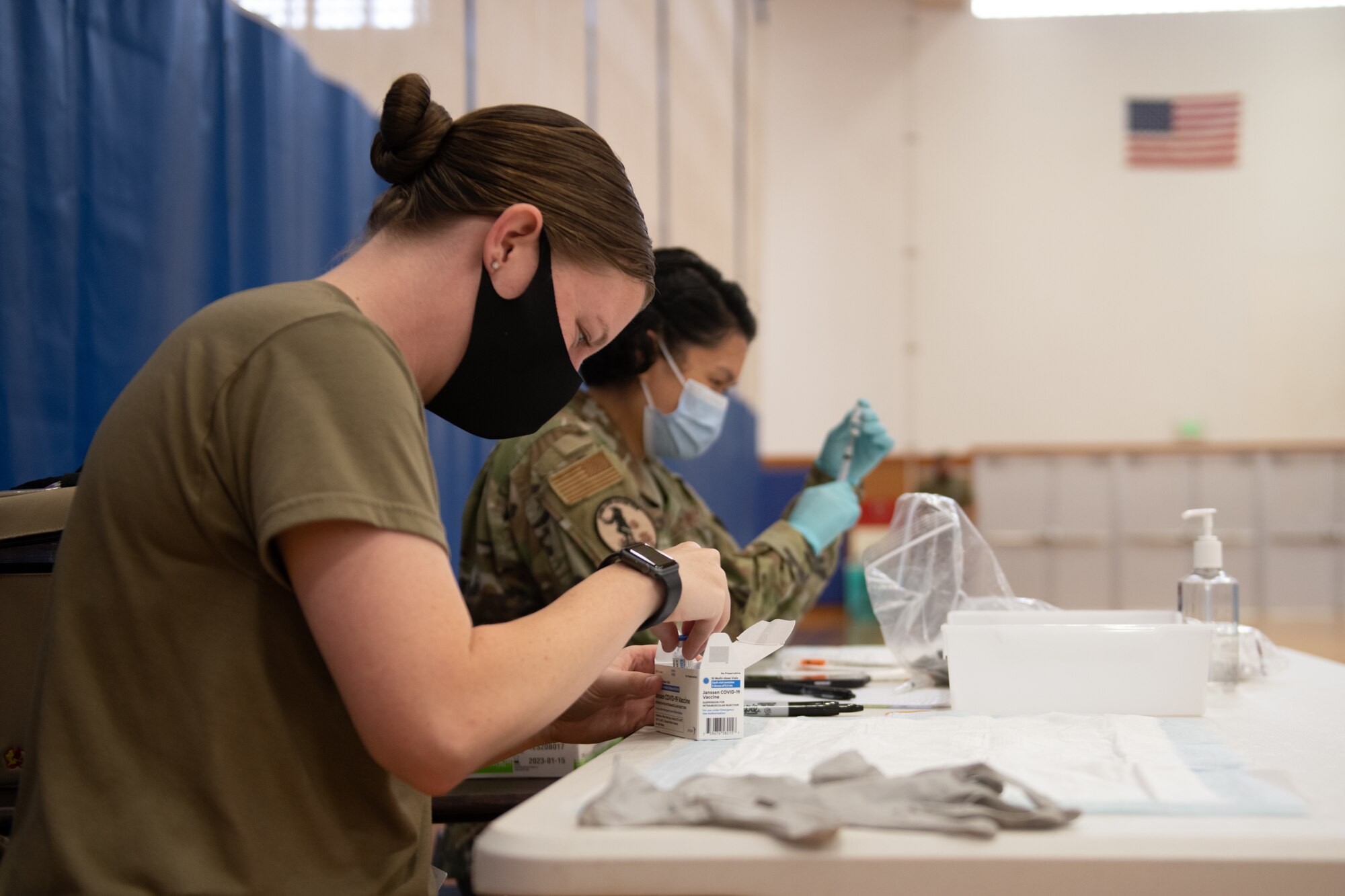 Airmen from the 18th Medical Group handle vials of the Janssen COVID-19 vaccine.