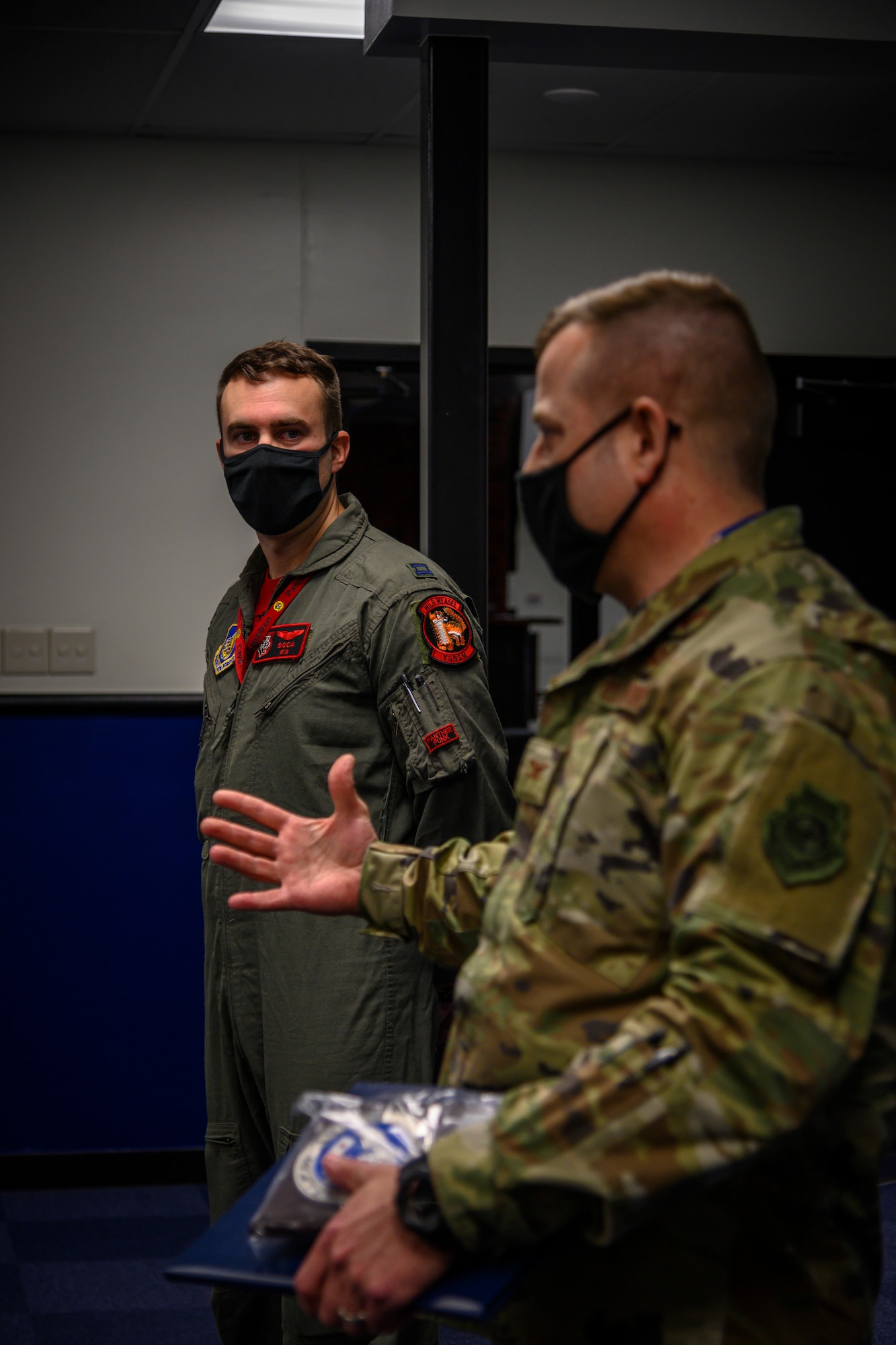 U.S. Air Force Capt. Spencer “Boca” Rhoton, left, a 13th Fighter Squadron F-16 Fighting Falcon pilot, listens to Col. Jesse J. Friedel, right, the 35th Fighter Wing commander speak at Misawa Air Base, Japan, April 7, 2021. Rhoton was hand-selected to accompany the 13th FS on the recent six-jet Agile Combat Employment-style deployment to Chitose during 5th Air Force’s Exercise PACIFIC RONIN and was named an Exercise “Superior Performer” by the 5th AF exercise team.. (U.S. Air Force photo by Airman 1st Class China M. Shock)