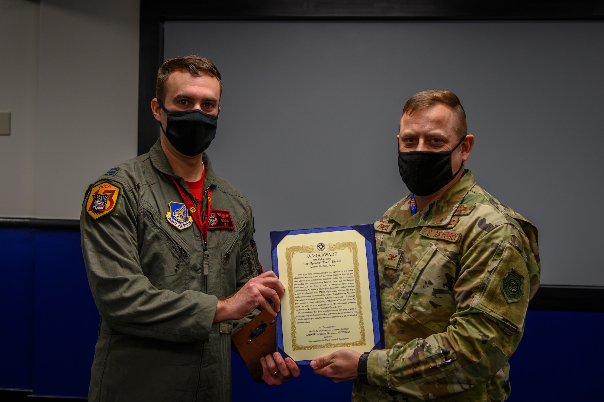 U.S. Air Force Capt. Spencer “Boca” Rhoton, left, a 13th Fighter Squadron F-16 Fighting Falcon pilot, receives the Japan-American Air Force Goodwill Association (JAAGA) award from Col. Jesse J. Friedel, right, the 35th Fighter Wing commander at Misawa Air Base, Japan, April 7, 2021. The JAAGA recognized Rhoton for his dedicated time to building a strong bond and partnership with the Japanese members at Misawa Air Base, Japan, April 9. (U.S. Air Force photo by Airman 1st Class China M. Shock)