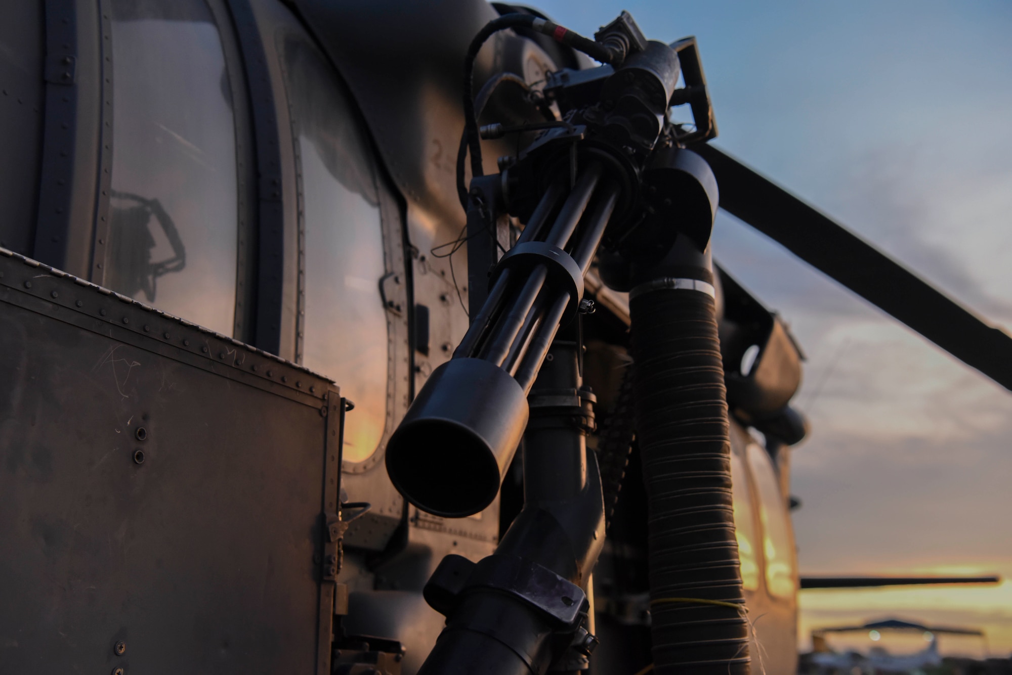 A mini gun sits on the side of a HH-60G Pave Hawk prior to an exercise at Camp Simba, Kenya, March 24, 2021.