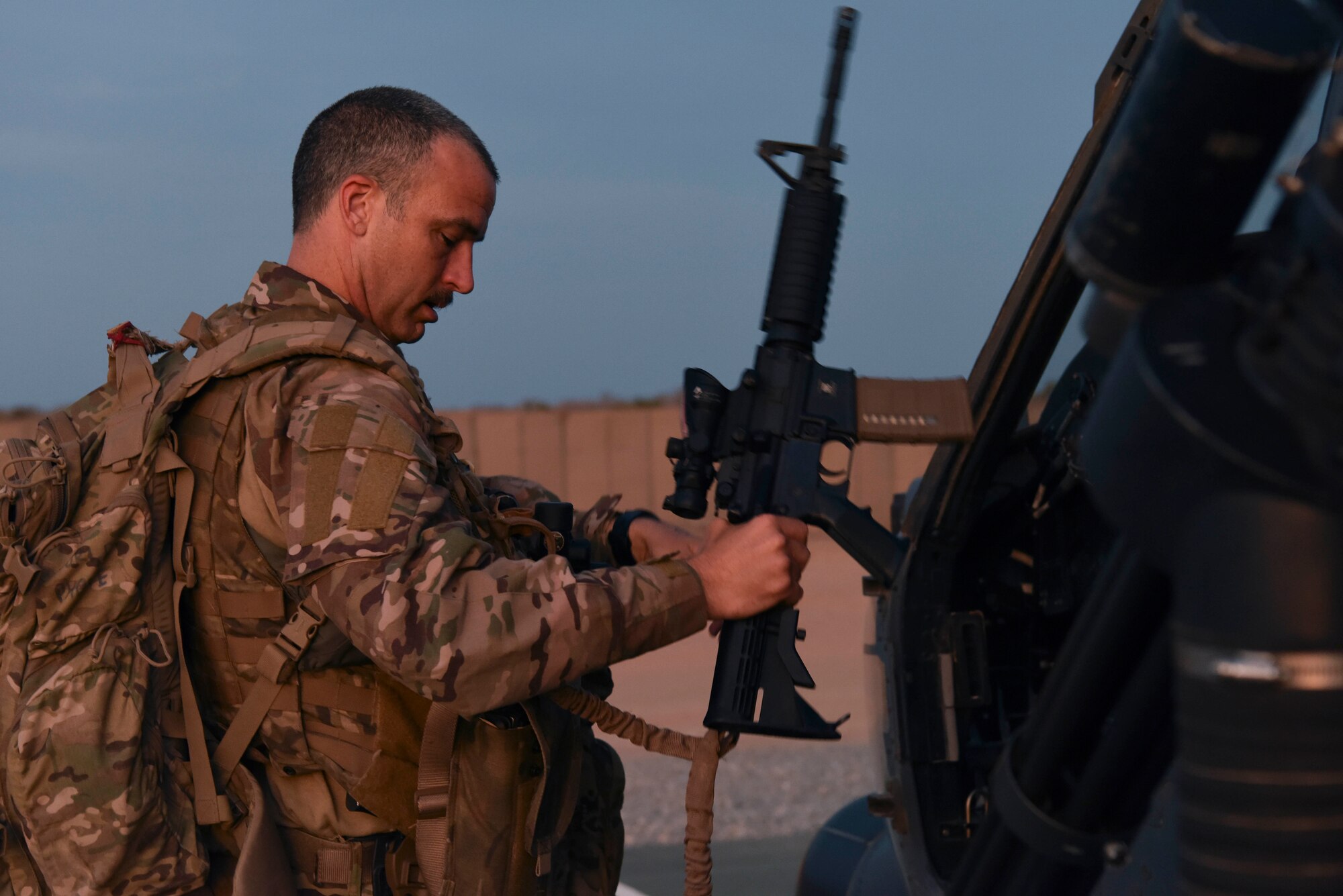 A U.S. Air Force service member assigned to the 303rd Expeditionary Rescue Squadron loads his gear prior to an exercise at Camp Simba, Kenya, March 24, 2021.