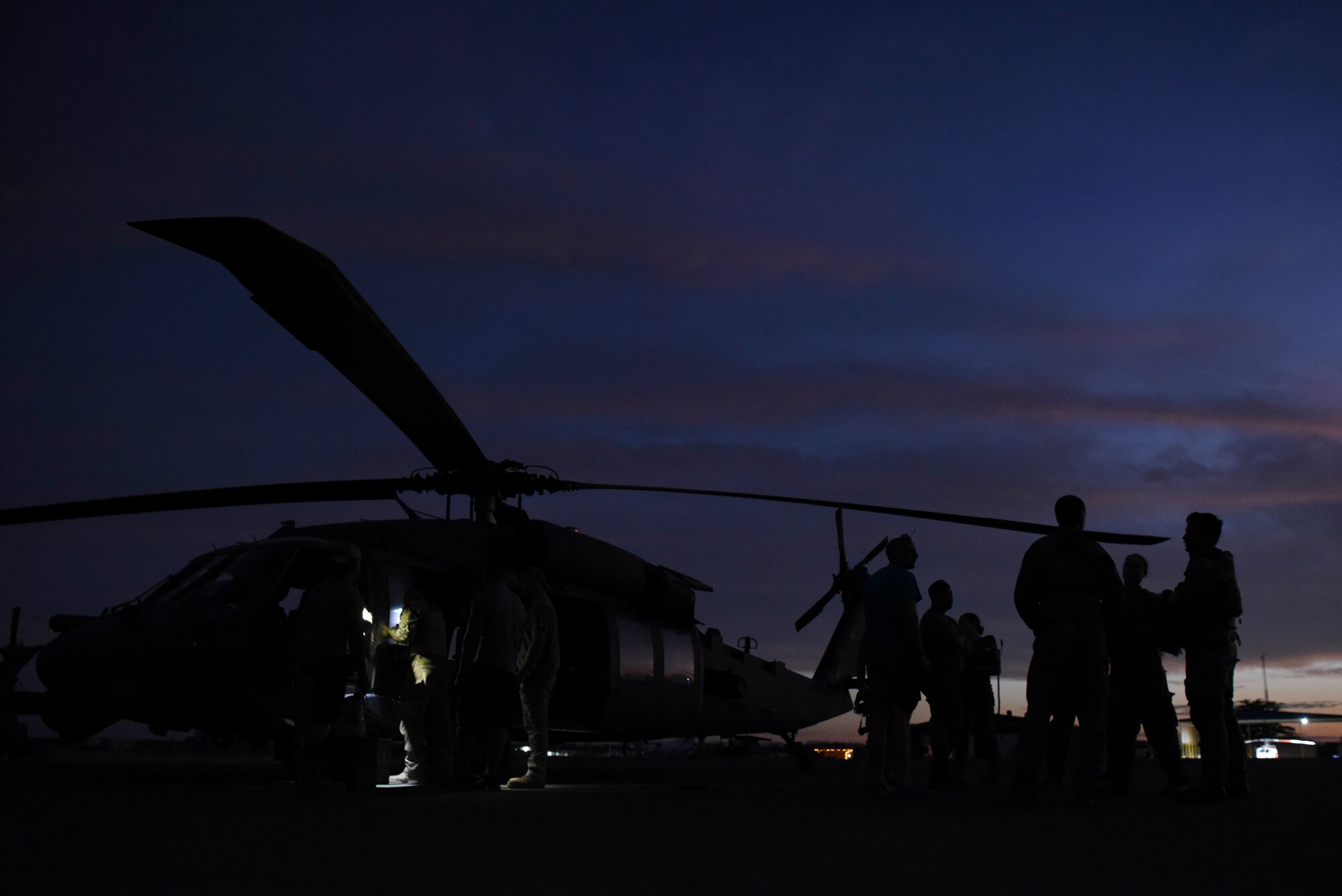 Members of the 303rd Expeditionary Rescue Squadron discuss last minute mission plans prior to boarding a HH-60G Pave Hawk during an exercise at Camp Simba, Kenya, March 24, 2021.