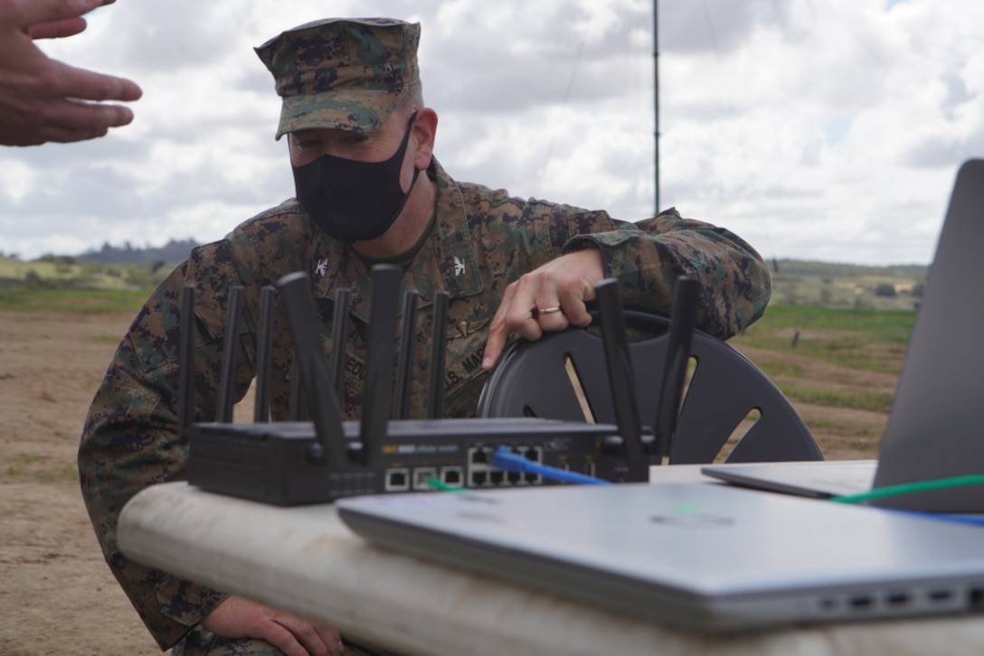 U.S. Marine Corps Col. Brian Rideout, commanding officer, I Marine Expeditionary Force Information Group, inspects the routing system for the Cloud Layered Obfuscation Application Kit during a practical exercise at Marine Corps Base Camp Pendleton, Calif., March 9, 2021. Project CLOAK uses commercial cloud computing resources to enhance the Marine Corps network system and secures global infrastructure.
