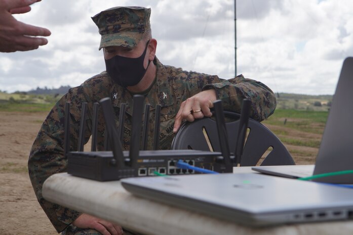 U.S. Marine Corps Col. Brian Rideout, commanding officer, I Marine Expeditionary Force Information Group, inspects the routing system for the Cloud Layered Obfuscation Application Kit during a practical exercise at Marine Corps Base Camp Pendleton, Calif., March 9, 2021. Project CLOAK uses commercial cloud computing resources to enhance the Marine Corps network system and secures global infrastructure.