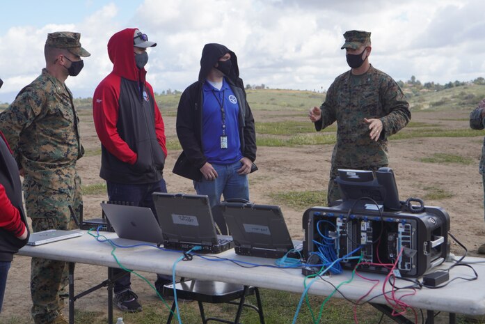 U.S. Marine Corps Col. Brian Rideout (right), commanding officer, I Marine Expeditionary Force Information Group discusses the vision for the Cloud Layered Obfuscation Application Kit during a practical exercise at Marine Corps Base Camp Pendleton, Calif., March 9, 2021. Project CLOAK uses commercial cloud computing resources to enhance the Marine Corps network system and secures global infrastructure.