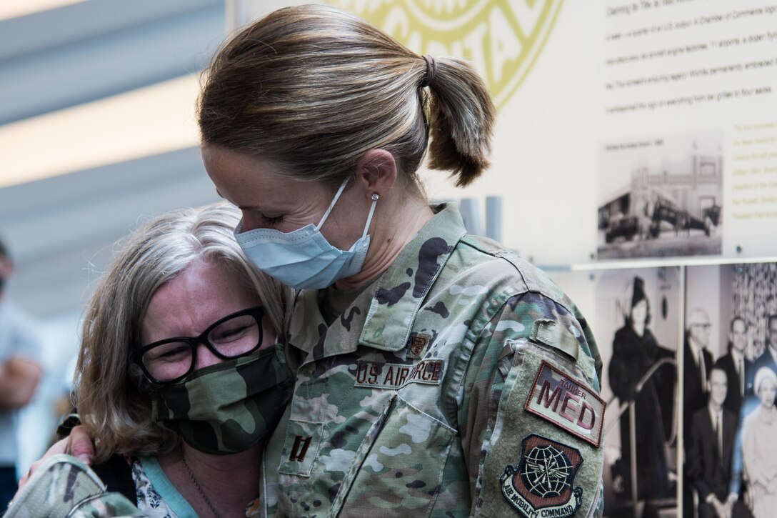 Lt Col. Lori Walker (left), 22nd Medical Group chief nurse, says goodbye to Capt. Anderson Wiksell, 22nd Medical Group practice manager, before Walker’s deployment to St. Paul, Minnesota, April 9, 2021. Medics from every military branch are currently supporting 39 Community Vaccination Centers in 19 states across the country, not including the site McConnell’s tanker medics will staff in Minnesota. (U.S. Air Force photo by Senior Airman Alexi Bosarge)