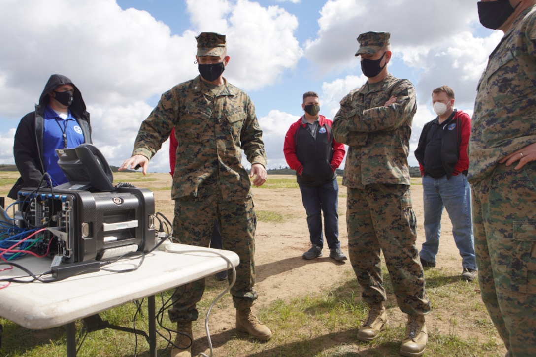 U.S. Marine Corps Lt. Col. Daniel Bartos (left) with Defense Information Systems Agency explains the concept of the Cloud Layered Obfuscation Application Kit to Col. Brian Rideout, commanding officer for I Marine Expeditionary Force Information Group, during a practical exercise at Marine Corps Base Camp Pendleton, Calif., March 9, 2021. Project CLOAK uses commercial cloud computing resources to enhance the Marine Corps network system and secures global infrastructure.