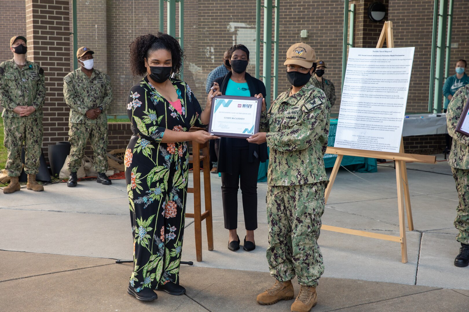 Four Sexual Assault Prevention and Response (SAPR) Victim Advocates (VAs) were selected as SAPR representatives of the year. Here, IT1 Cindy McCandies from Fleet Cyber Command receives an award from Norfolk Naval Shipyard's (NNSY) Sexual Assault Response Coordinator (SARC) Shalise Bates-Pratt and Federal Women’s Program (FWP) president Aiya Williams.