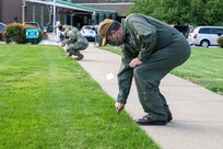 USS George H.W. Bush (CVN 77) Commanding Officer Capt. Robert Aguilar plants a flag of support in the ground outside of Norfolk Naval Shipyard's Engineering and Management Building during the shipyard's Sexual Assault Awareness and Prevention Month (SAAPM) kickoff event April 9.